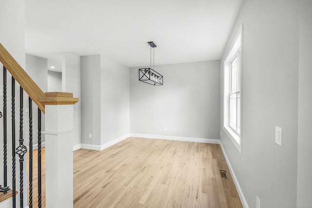 empty room with light hardwood / wood-style floors and a wealth of natural light