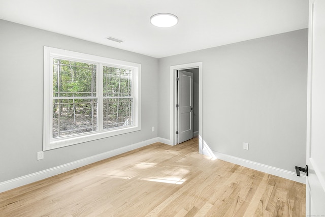 spare room featuring light hardwood / wood-style floors