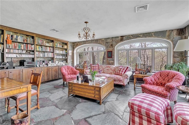 living room featuring a chandelier and a textured ceiling