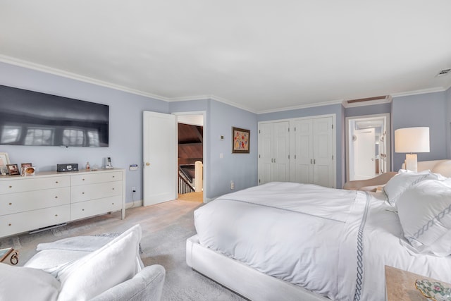 bedroom with ornamental molding and light colored carpet