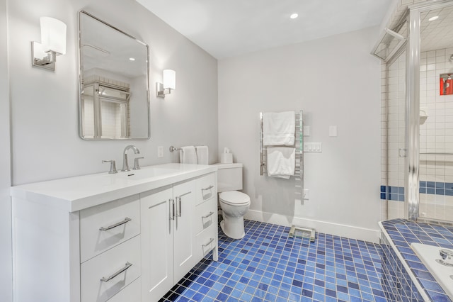 bathroom with tiled shower, vanity, toilet, and tile patterned floors