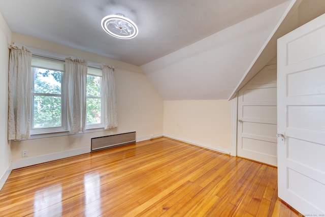 bonus room featuring vaulted ceiling and light hardwood / wood-style floors