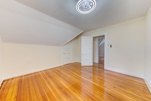 bonus room with light hardwood / wood-style flooring and lofted ceiling