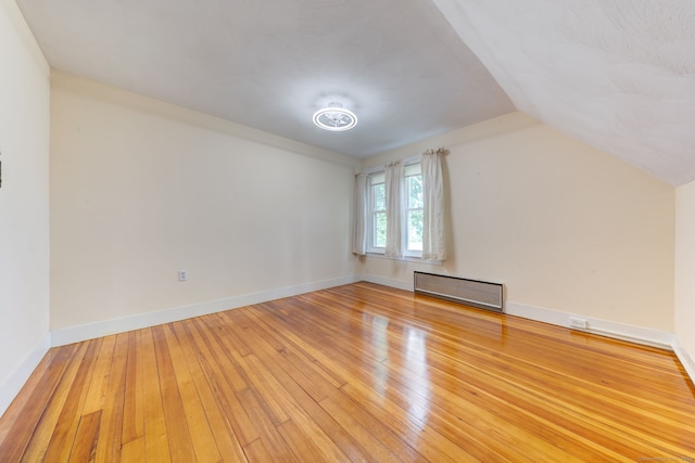 bonus room featuring hardwood / wood-style flooring and vaulted ceiling