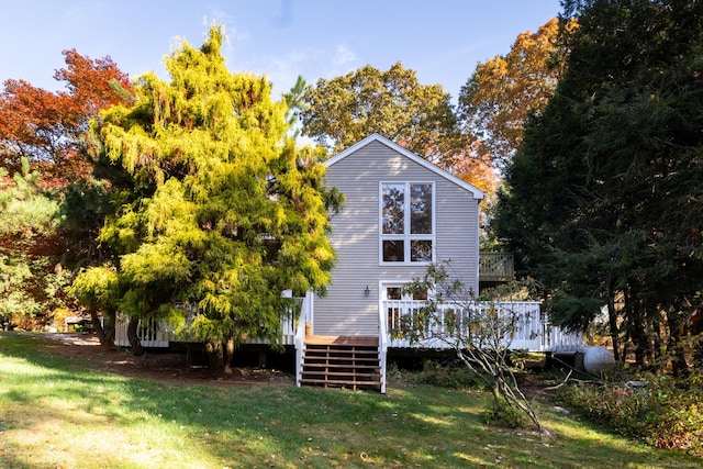 back of house featuring a yard and a deck