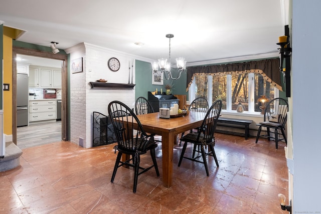 dining space with a chandelier, baseboard heating, a fireplace, and crown molding