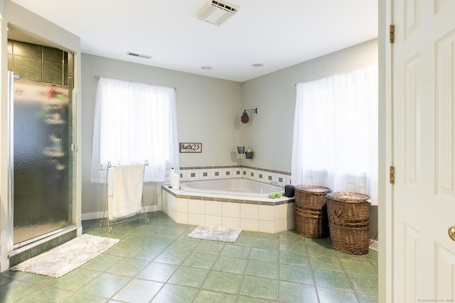 bathroom featuring tile patterned flooring and separate shower and tub