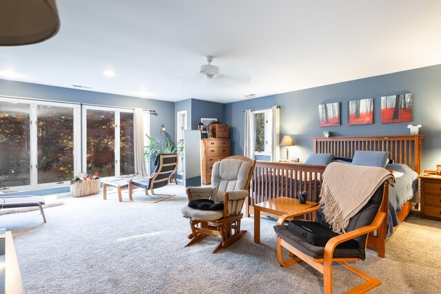 bedroom featuring multiple windows, ceiling fan, and carpet