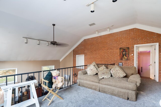 living room featuring ceiling fan, lofted ceiling, brick wall, and track lighting