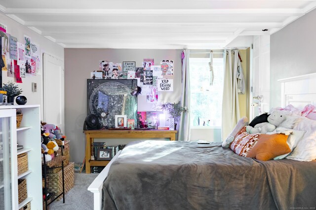 bedroom with carpet flooring and beamed ceiling