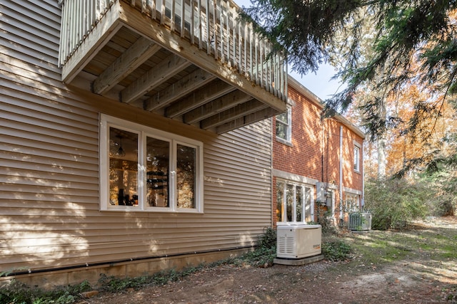 view of side of home featuring central AC