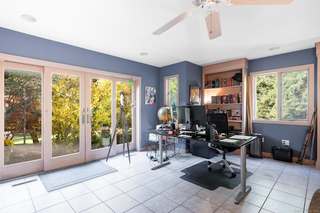 unfurnished office featuring ceiling fan, light tile patterned floors, and french doors