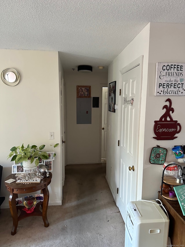 hallway with light colored carpet, a textured ceiling, and electric panel