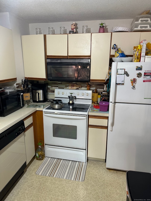 kitchen with white appliances and a textured ceiling