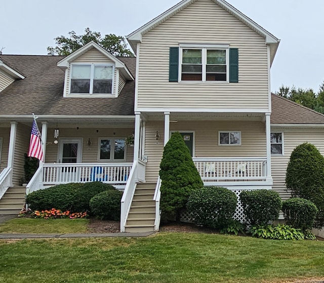 view of front of home with a front yard and covered porch