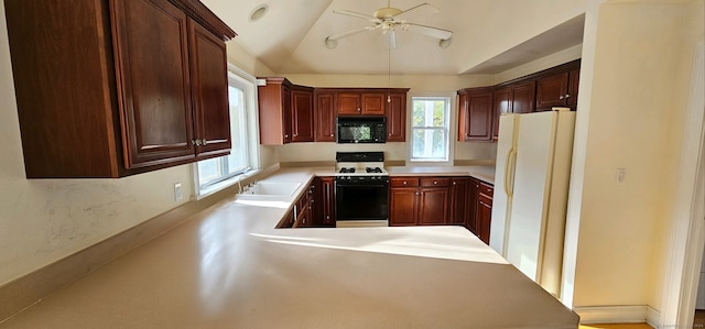 kitchen with ceiling fan, lofted ceiling, sink, kitchen peninsula, and white appliances