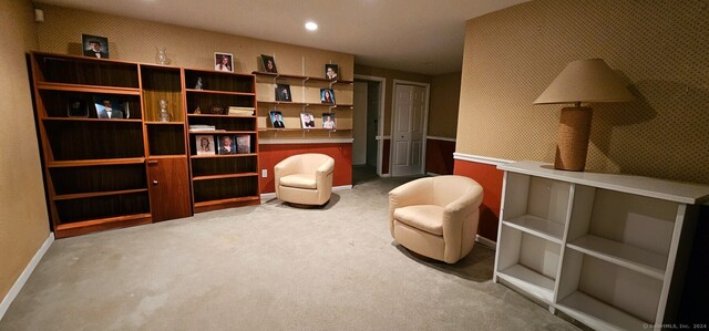 living area featuring carpet