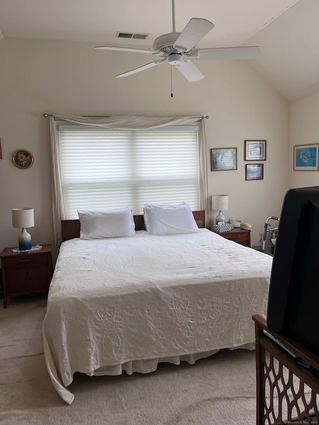 carpeted bedroom featuring lofted ceiling and ceiling fan