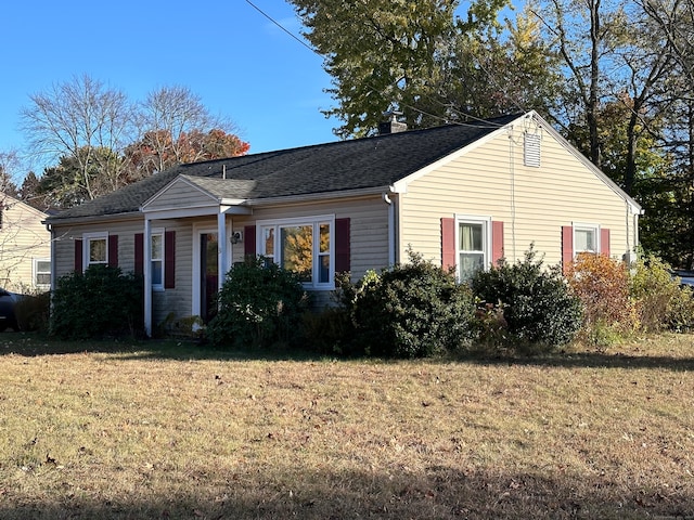 single story home featuring a front lawn