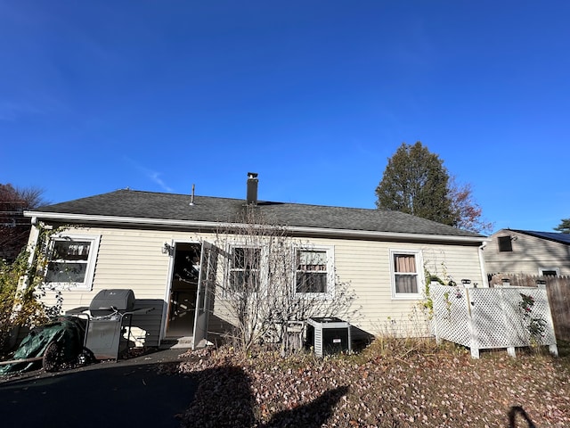 rear view of house featuring cooling unit