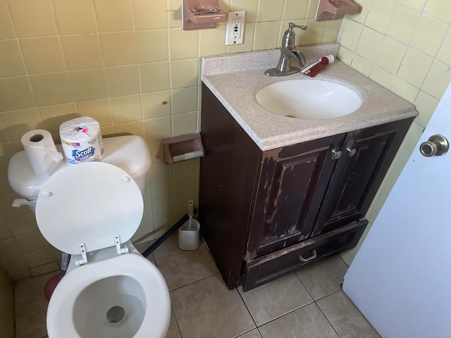 bathroom featuring tile walls, vanity, and toilet