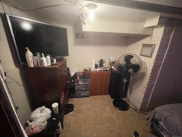 interior space with light tile patterned floors and crown molding