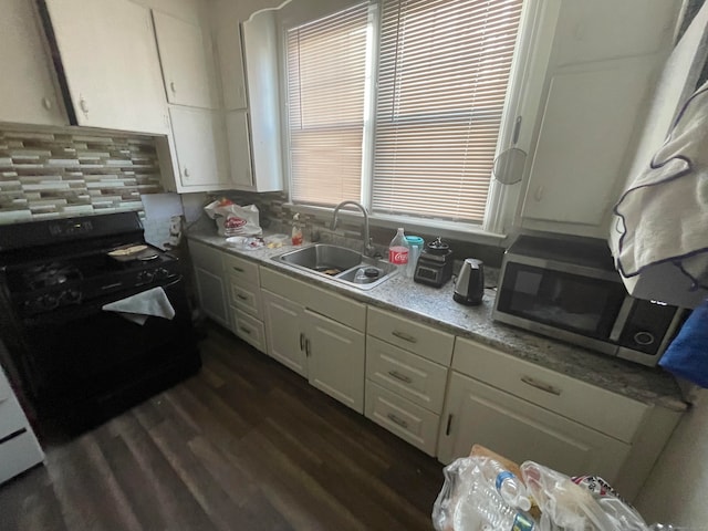 kitchen featuring sink, white cabinets, decorative backsplash, dark hardwood / wood-style flooring, and black range with electric cooktop