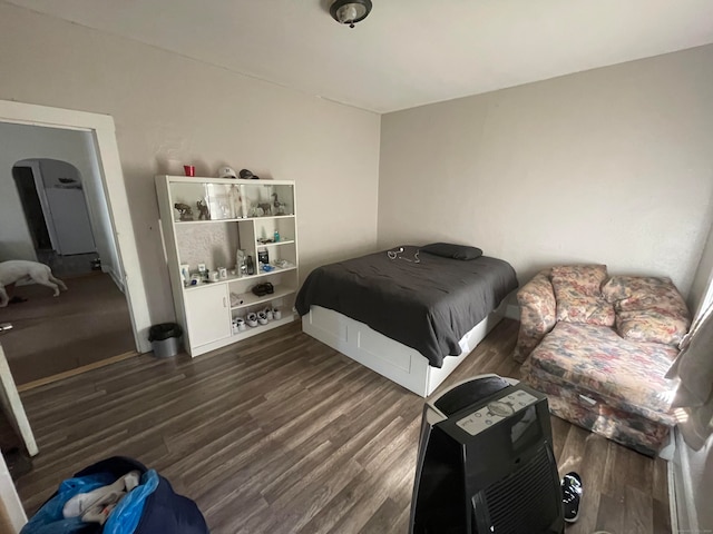 bedroom with dark hardwood / wood-style floors