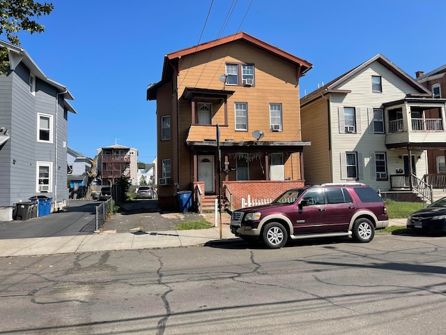 view of front property featuring a balcony