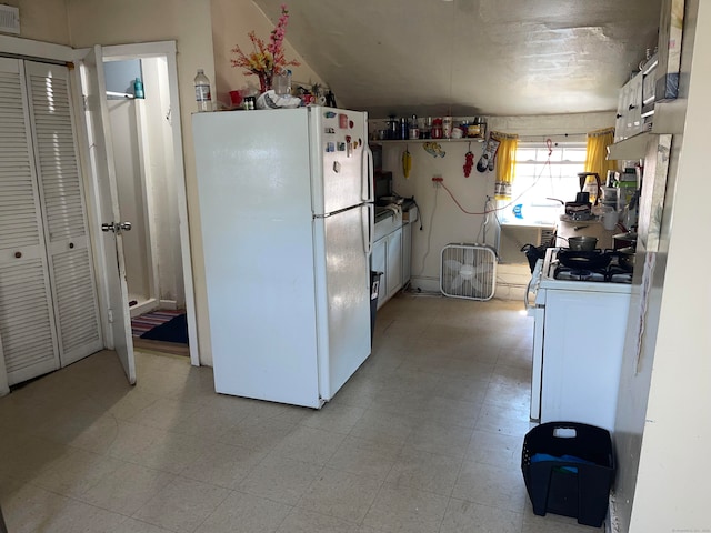 kitchen featuring white appliances and white cabinetry