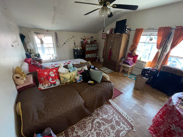 bedroom with ceiling fan, light wood-type flooring, vaulted ceiling, and multiple windows