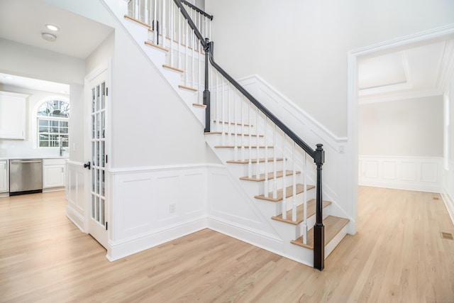 stairway with wood-type flooring and sink