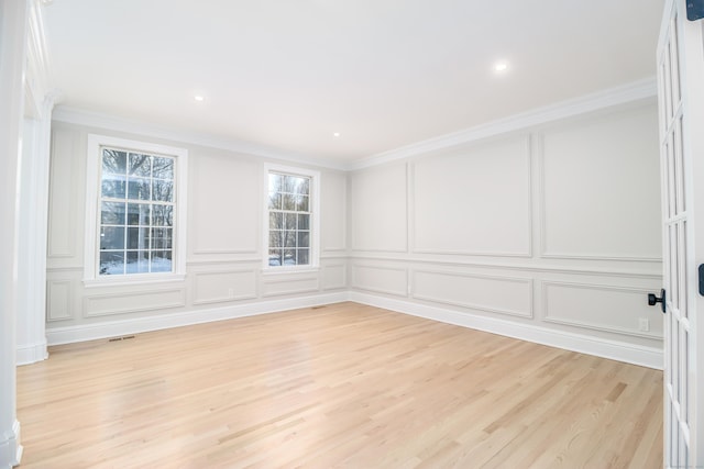 unfurnished room featuring light hardwood / wood-style floors and ornamental molding