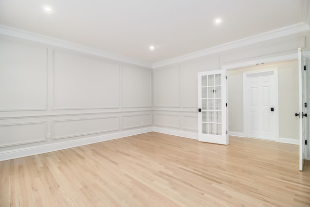 empty room featuring light hardwood / wood-style flooring and ornamental molding