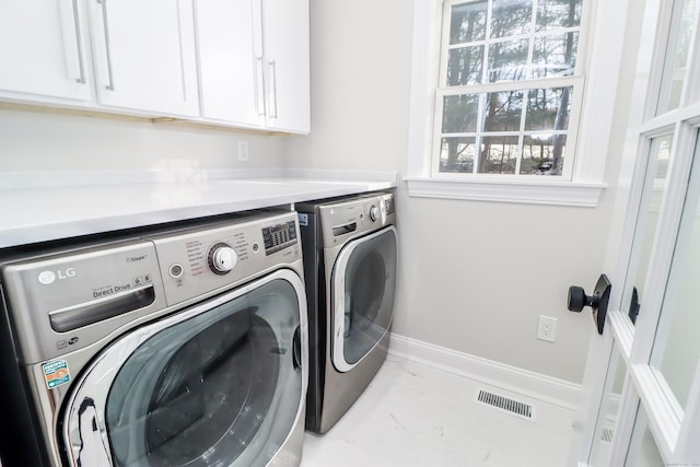 laundry room with cabinets and washer and dryer