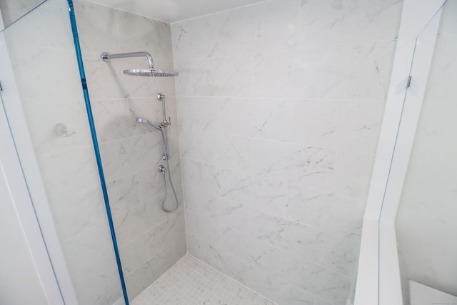 bathroom with a tile shower