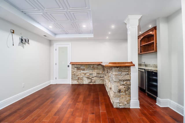 bar with dark hardwood / wood-style floors, dishwasher, beverage cooler, and decorative columns