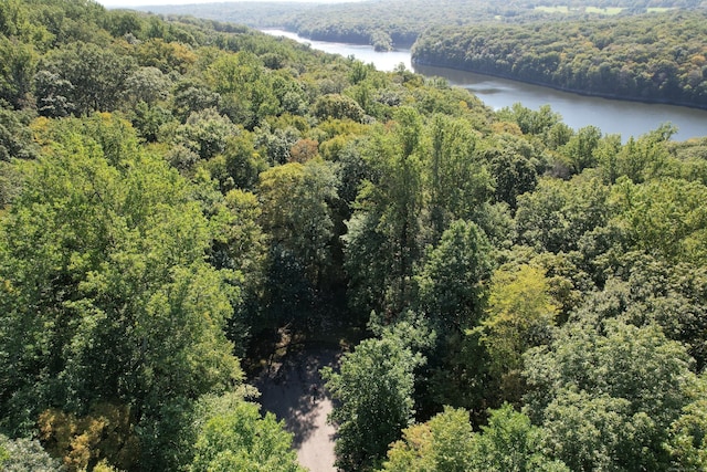drone / aerial view featuring a water view and a forest view