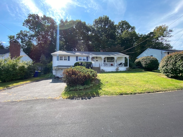 view of front of property with a front lawn and covered porch