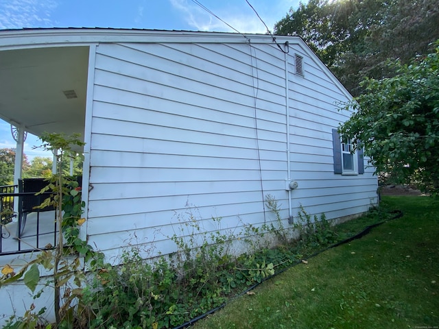 view of property exterior featuring a lawn