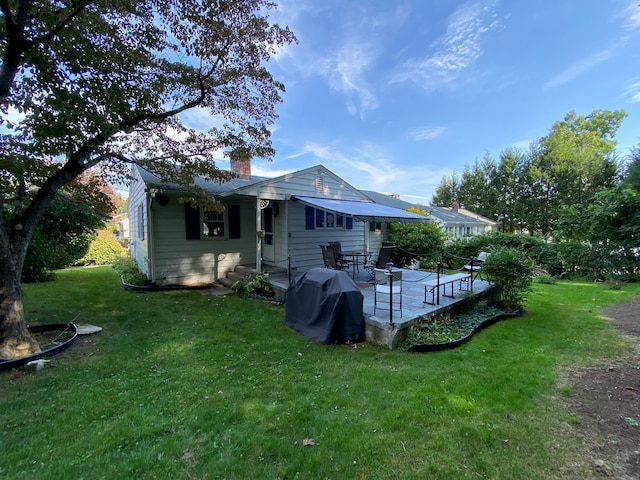 back of house with a lawn and a wooden deck