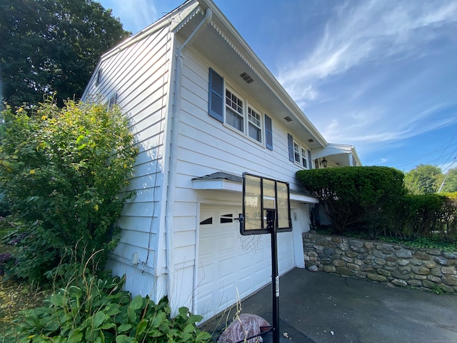 view of side of home with a garage