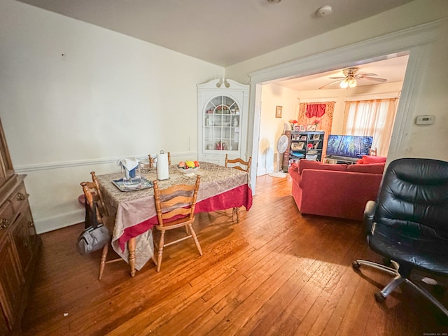 dining room featuring wood-type flooring and ceiling fan