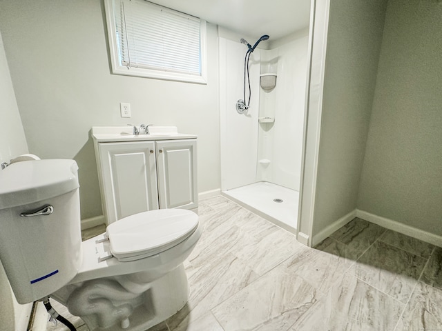 bathroom featuring vanity, a shower, and toilet