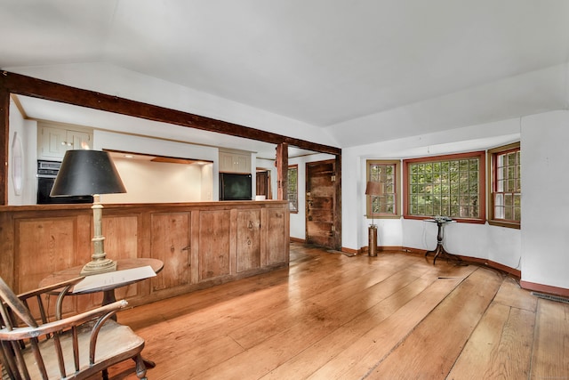 sitting room featuring light wood-type flooring and vaulted ceiling