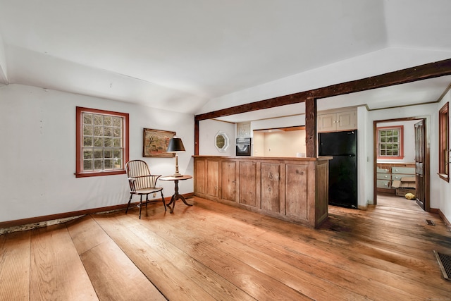 interior space with light hardwood / wood-style floors and lofted ceiling