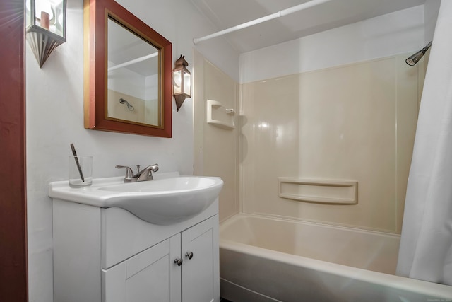 bathroom featuring vanity and shower / bathtub combination with curtain