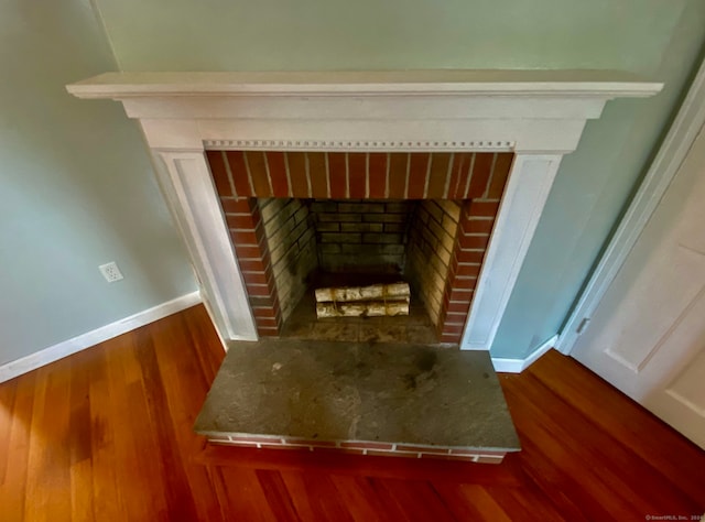 room details with hardwood / wood-style flooring and a fireplace