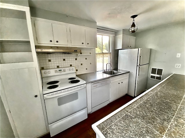 kitchen featuring decorative backsplash, white cabinets, white appliances, decorative light fixtures, and sink