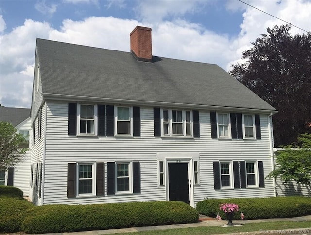 colonial-style house with a front yard